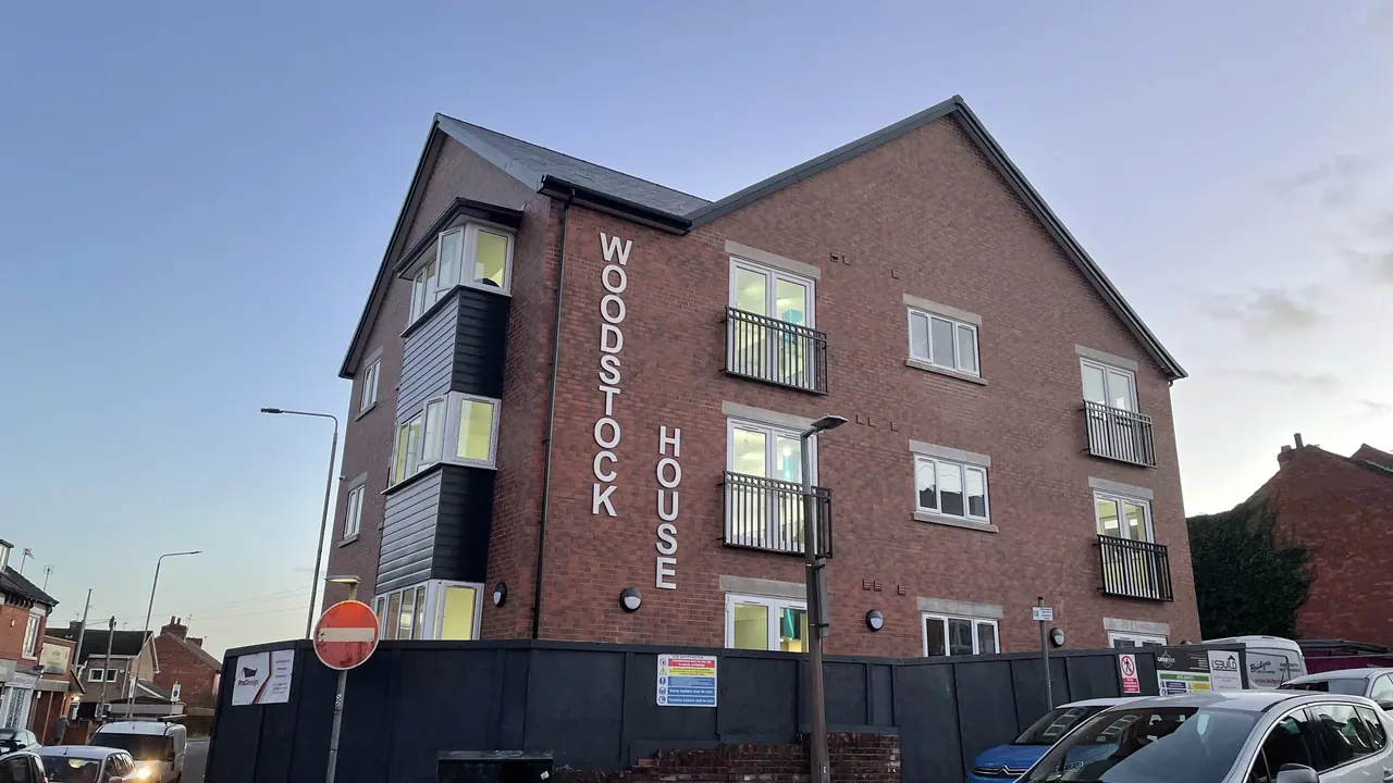 Vertical building name sign on a residential block
