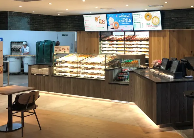 Bakery counter with digital menu screens above